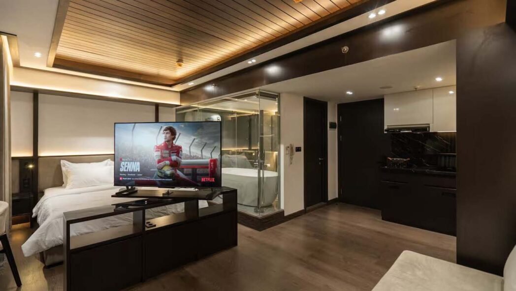 A sleek and stylish apartment interior in M Town, designed with dark wood textures.