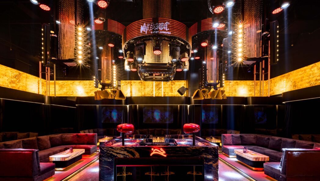 WhiteRabit Gatot Subroto is a bold and immersive nightclub concept defined by dramatic lighting, dark materials, and striking red and gold accents.